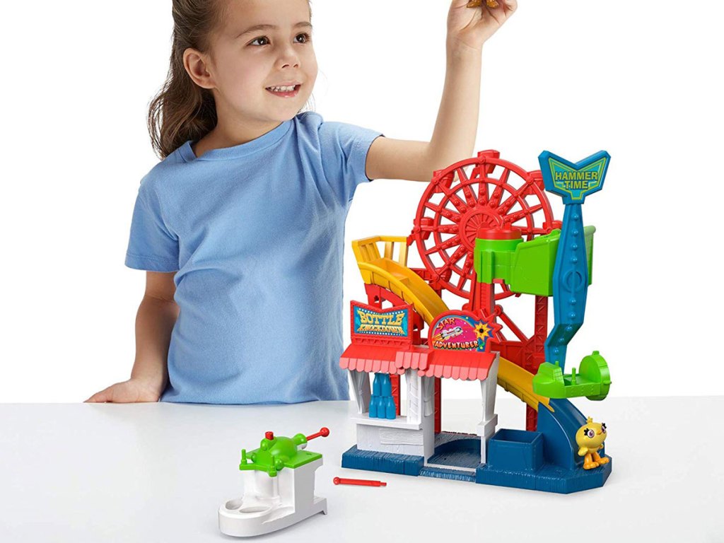 girl playing with Fisher-Price Imaginext Disney Pixar Toy Story 4 Carnival Playset