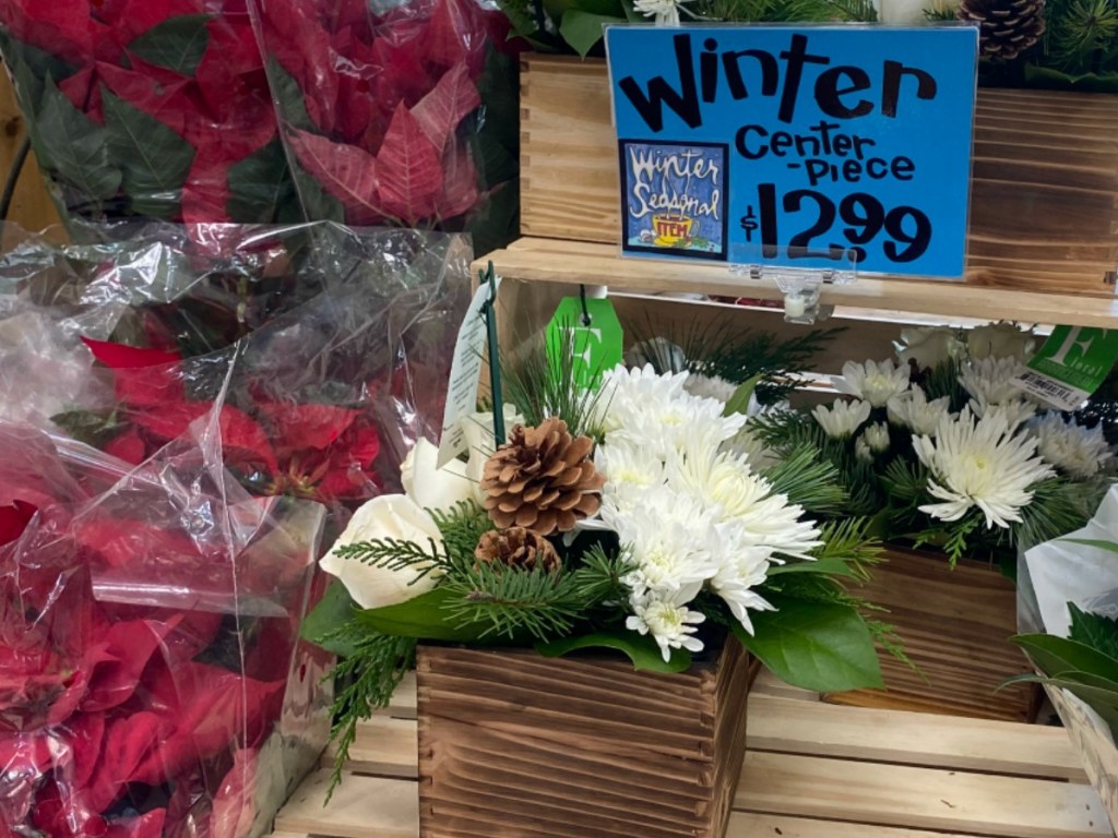 flower arrangment sitting on wooden box of store display