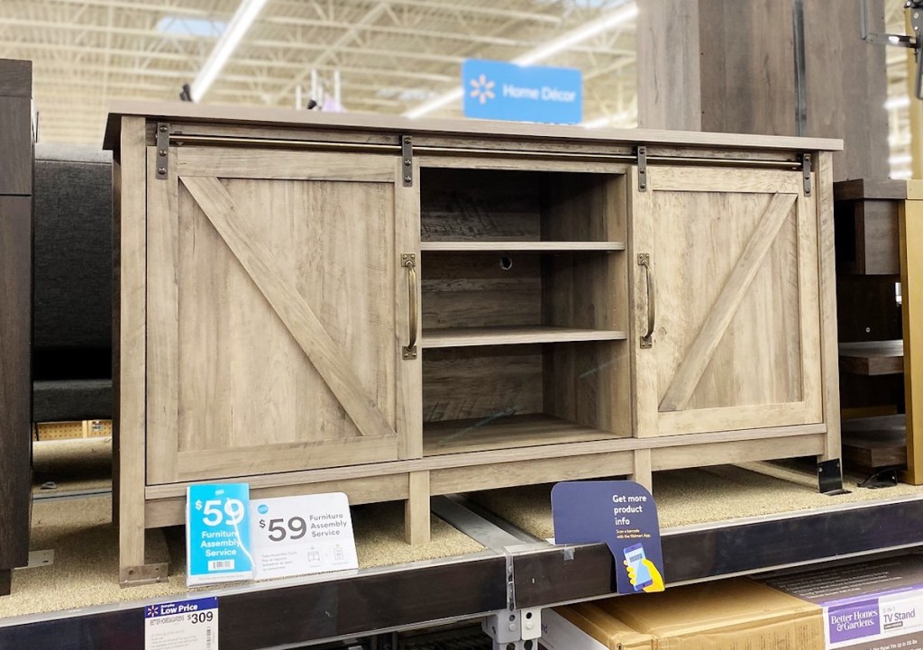 gray farmhouse tv console stand sitting on store shelf