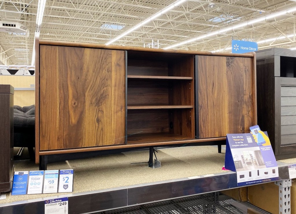 wooden tv stand sitting on store shelf 