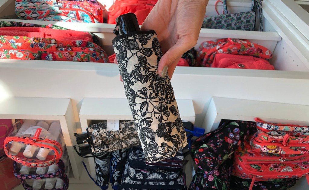 hand holding a black and white floral umbrella 