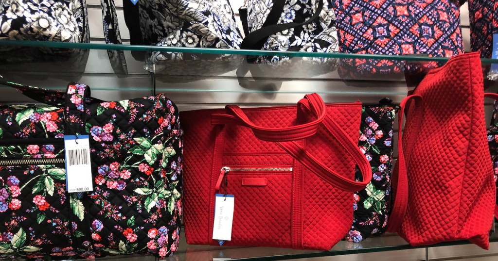 bright red and floral vera bradley bags on store shelf 