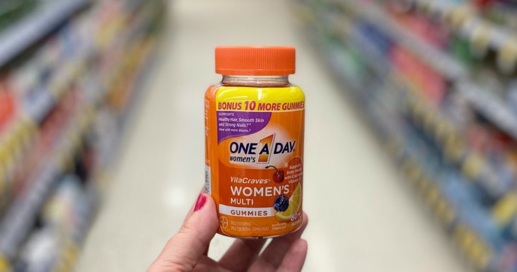 hand holding vitamin bottle in a store