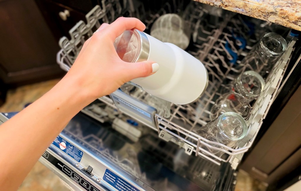 hand holding white yeti mug over open dishwasher