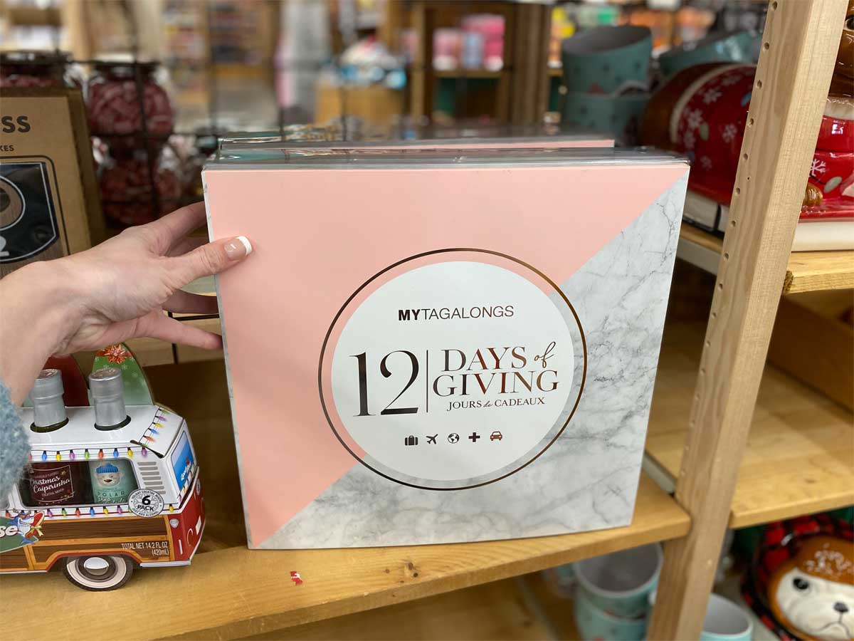 woman hand holding 12 Days Of Giving Christmas Countdown Calendar