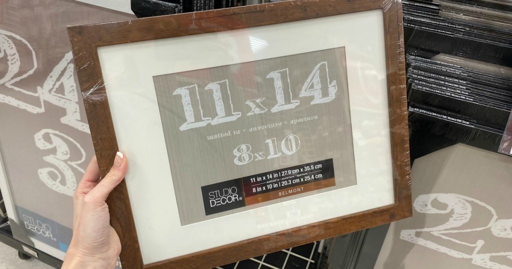 woman holding an 11x14 wooden frame
