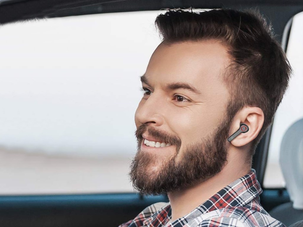 Man sitting in a car wearing Boltine Wireless Earbuds