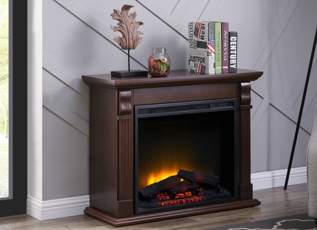 Chestnut colored wooden detailed fireplace in living room with decor on mantle 