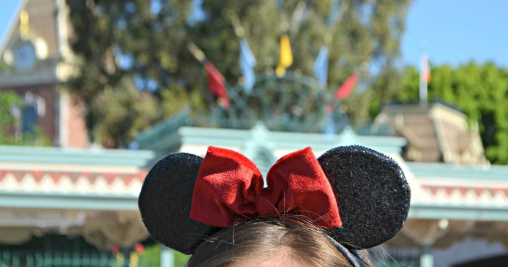 Girl wearing minnie mouse ears at Disney park