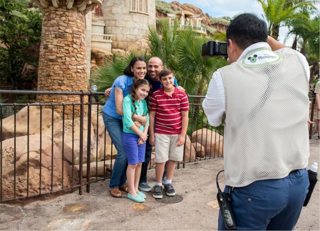 family getting their photo taken by Disney employee at Disney World