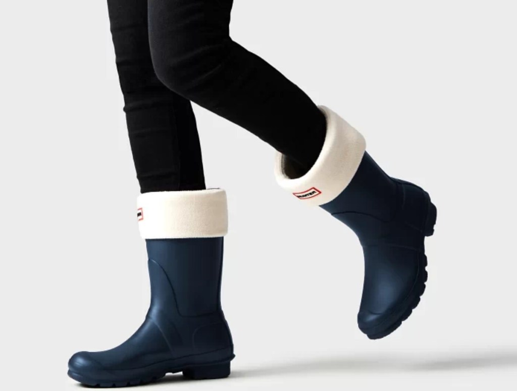woman in black leggings and short rain boots with boot socks