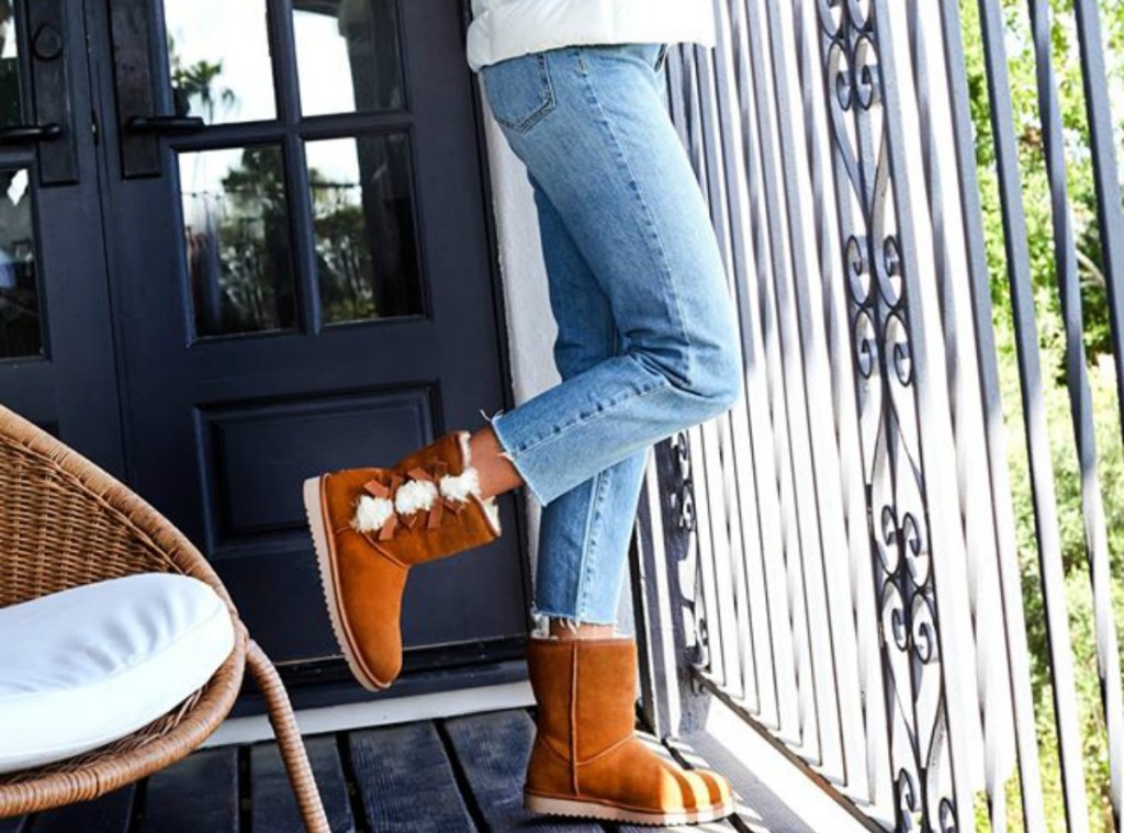 woman wearing brown suede boots with bows in the back