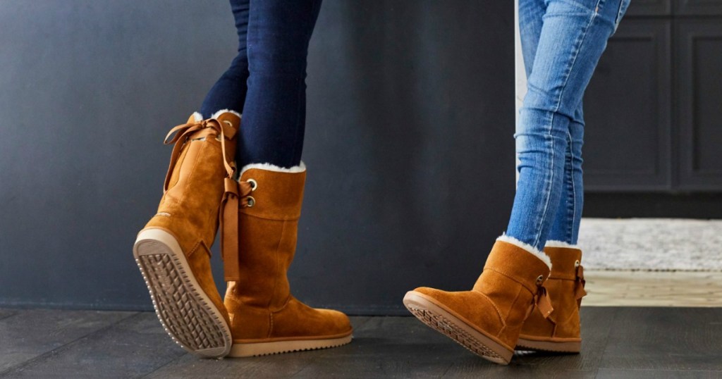 woman and girl wearing brown suede UGG boots and jeans