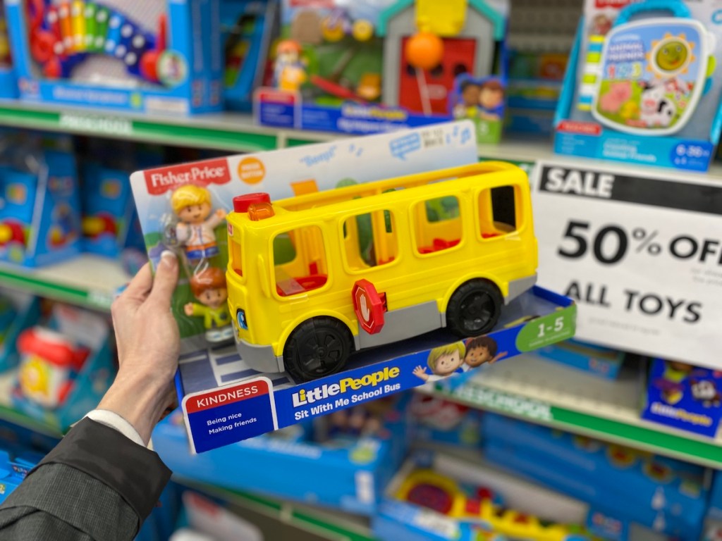 hand holding Little People Fisher-Price Bus