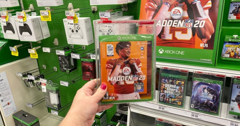 hand holding madden 20 video game in store