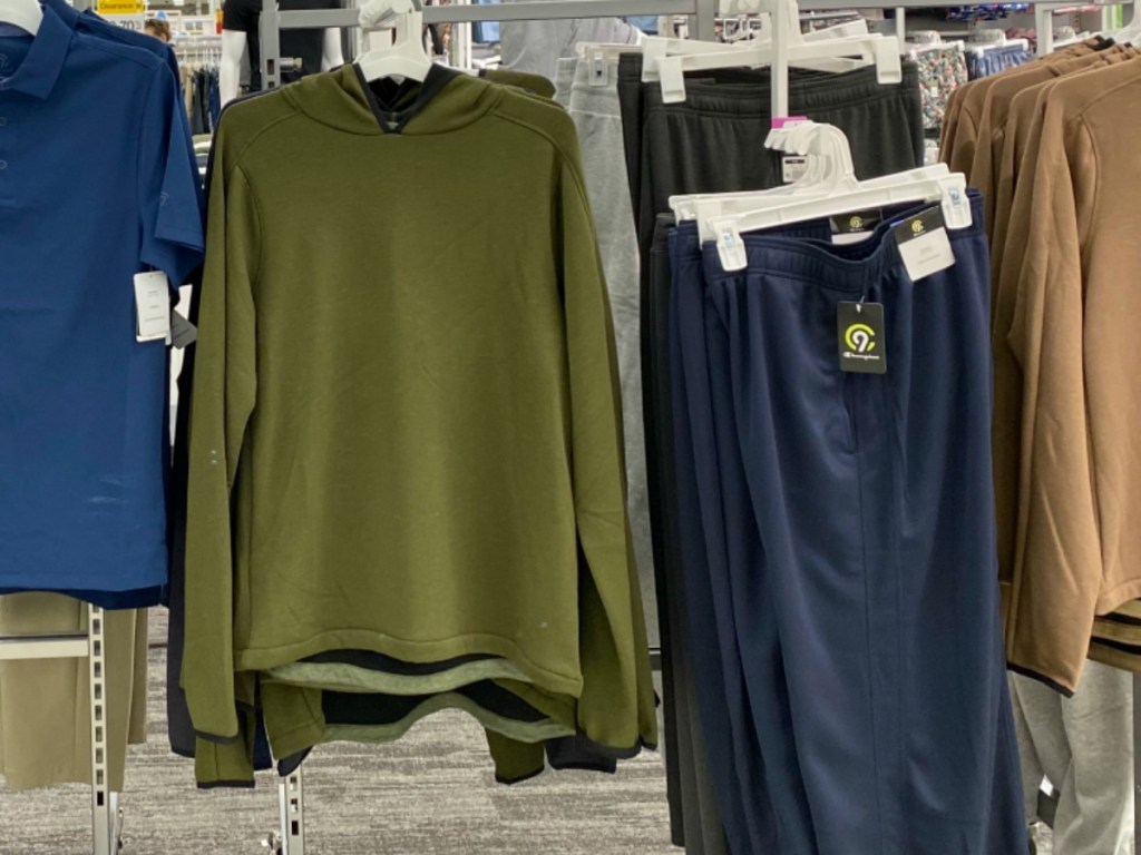 Men's hoodie in green on display in-store near athletic apparel