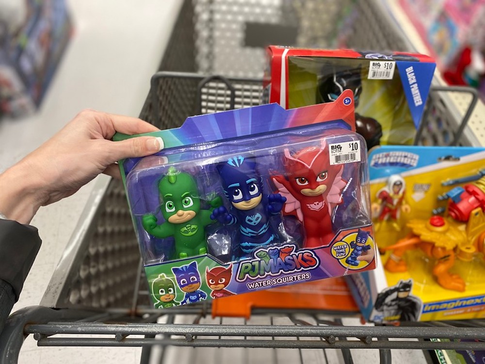 hand holding PJ Masks Bath Squirters by Big Lots cart