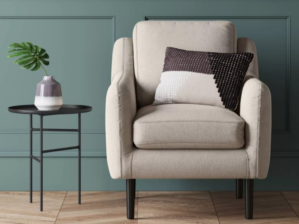 white armchair in front of a green wall