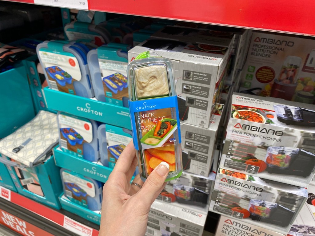 Woman's Hand holding Snack on the go container in ALDI