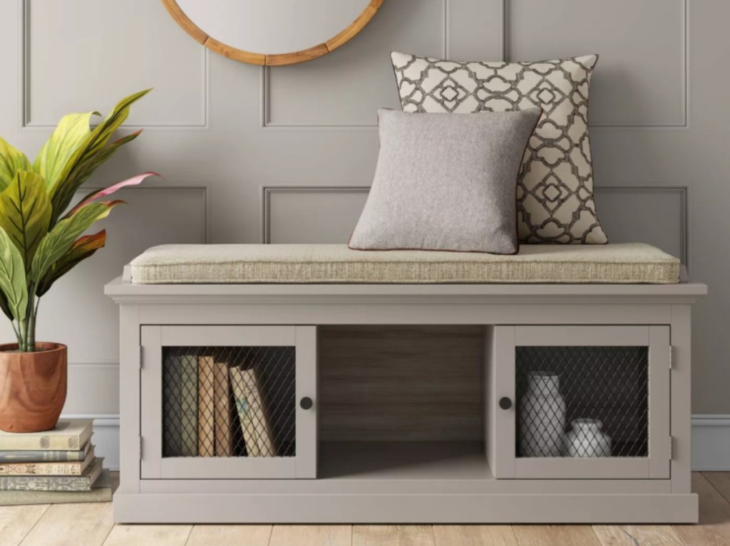 gray entryway bench with throw pillows on top