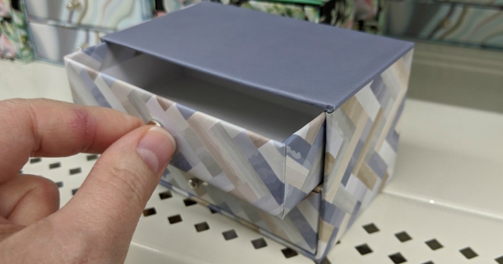 hand opening drawer of trinket box at Dollar Tree