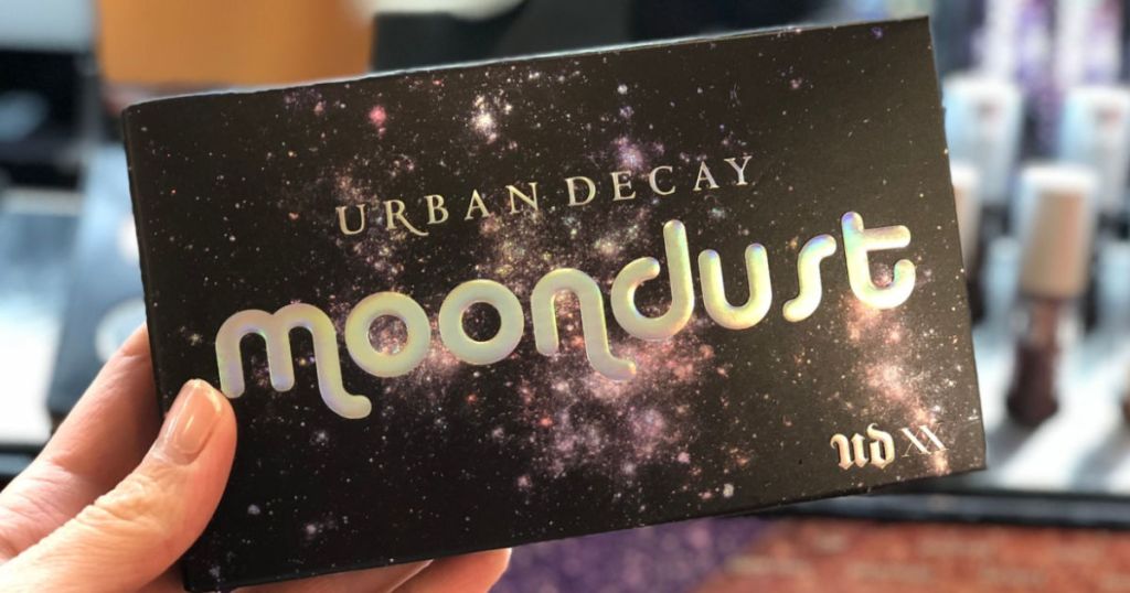 hand holding Urban Decay Moondust Eyeshadow Palette
