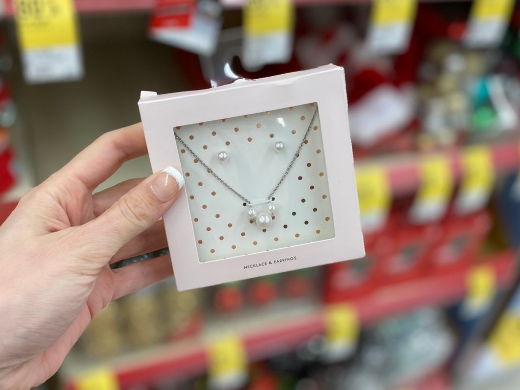 Hand holding Walgreens pearl earring set