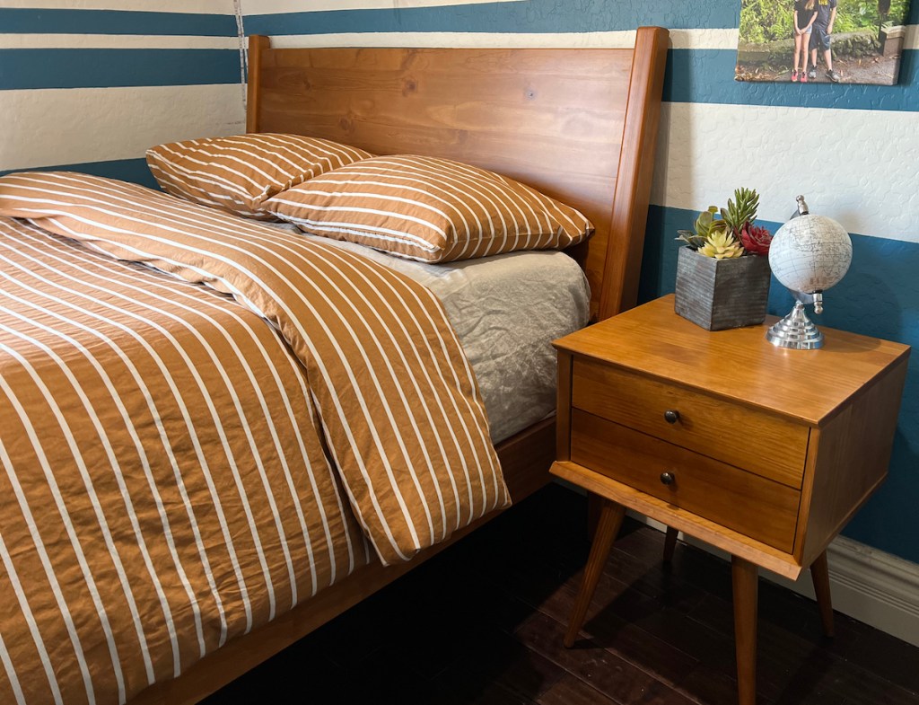 mid century modern bed with stripe bedding 