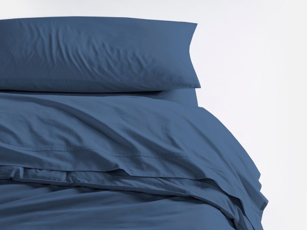 navy sheets and pillow case on bed
