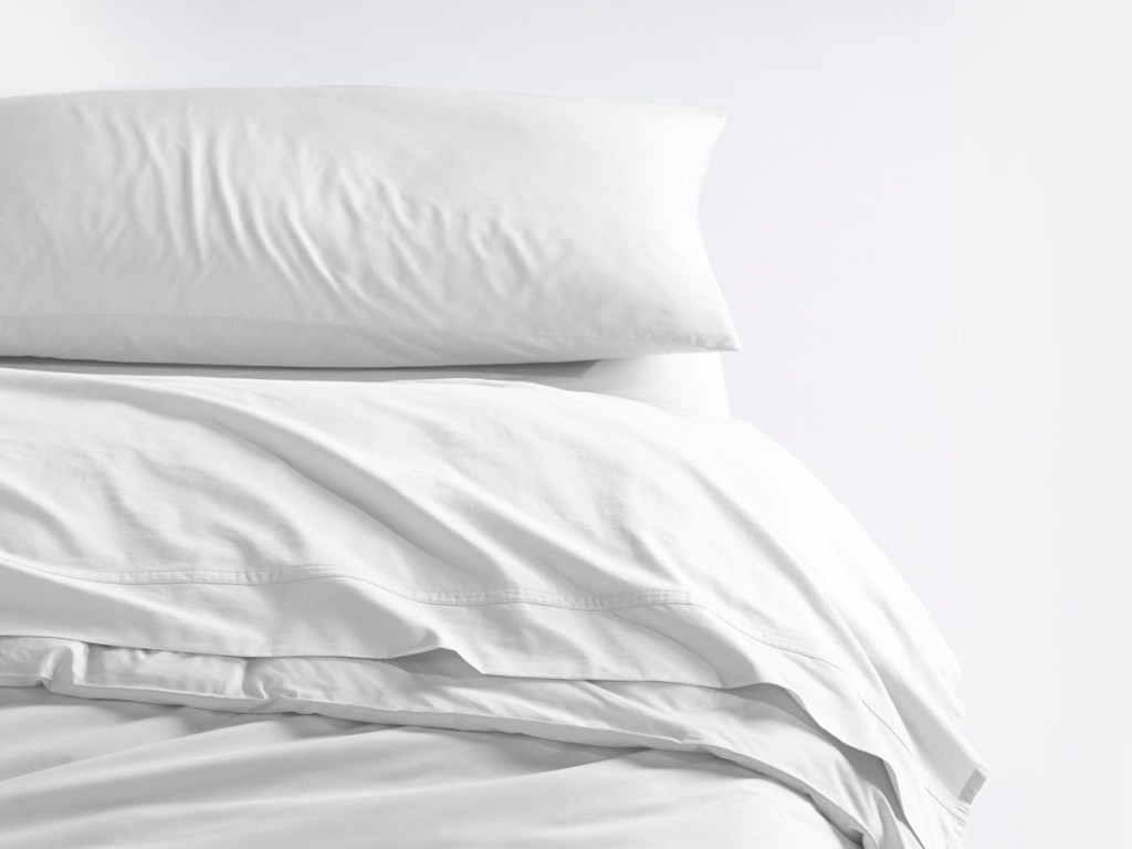 gray sheets and pillowcase on bed