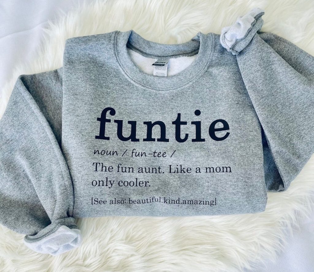 funtie gray sweatshirt laying on white faux fur 