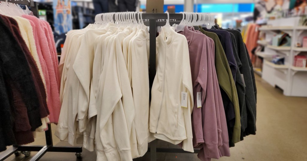 white, pink, green and blue performance fleece on rack in store