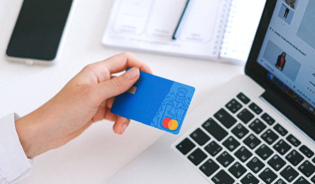 woman holding credit card to pay online