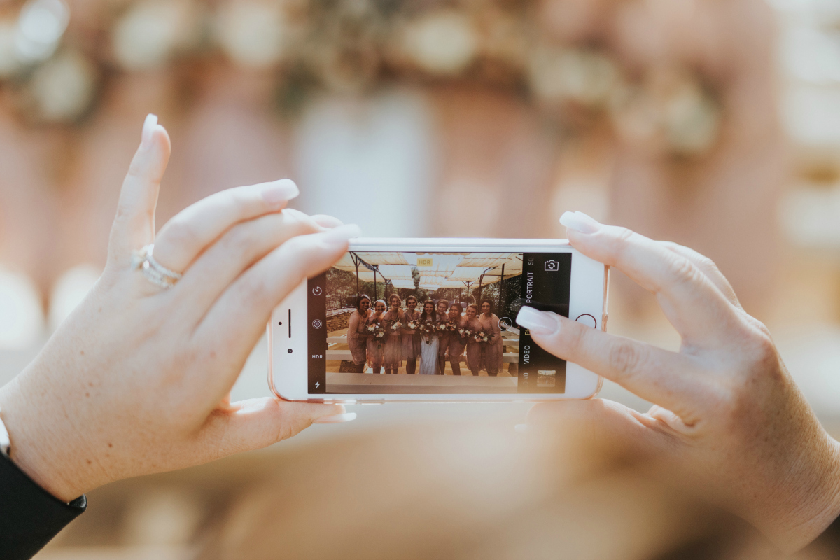 person taking wedding photos on iPhone
