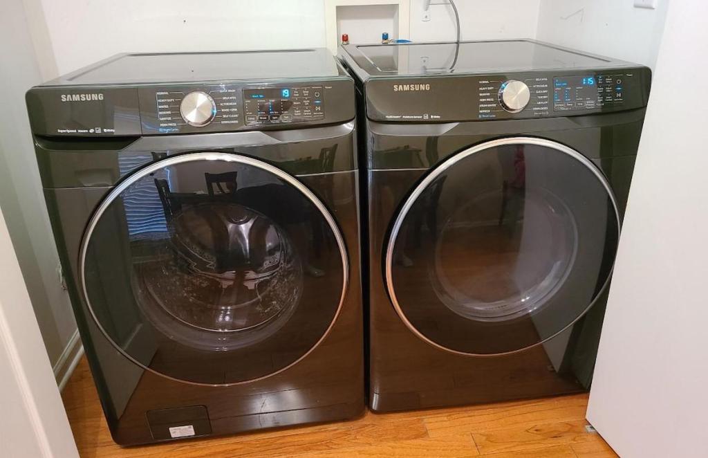 dark gray washer and dryer sitting in laundry room