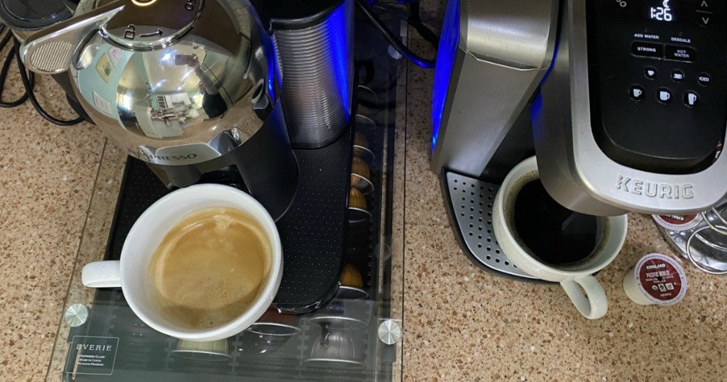 nespresso and keurig machines on counter with coffee mugs 