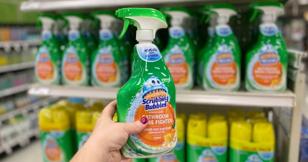 hand holding scrubbing bubbles bathroom cleaner in a target store