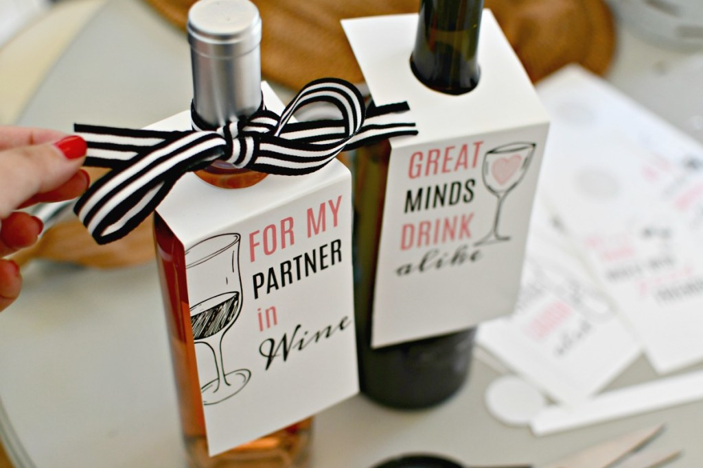tying a bow and gift tag to bottle