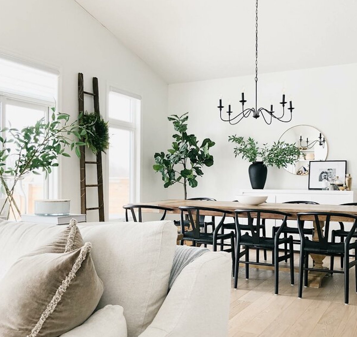 pottery barn decor inspired chandelier hanging over dining room table and chairs