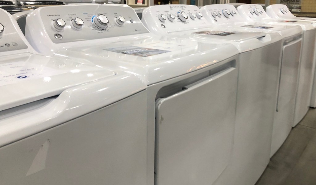 row of white laundry room appliances