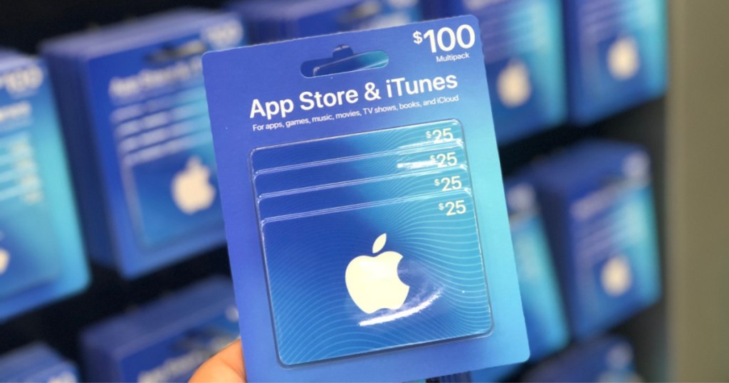 hand holding $100 iTunes Gift Card