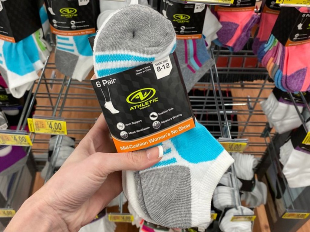 Woman holding pack of socks in store