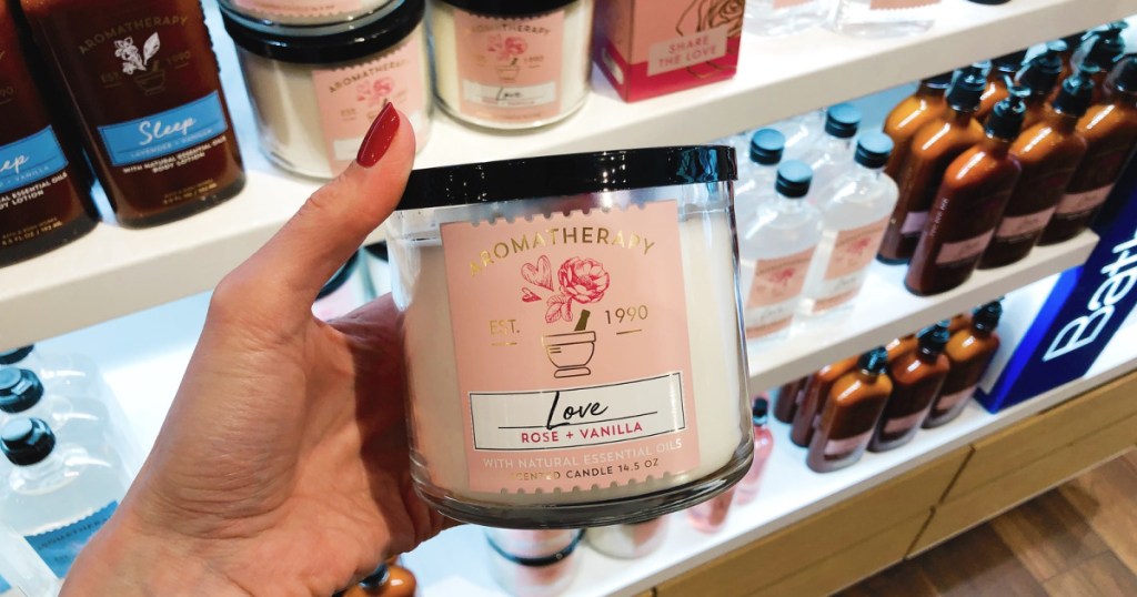 hand holding a Love Aromatherapy candle at Bath & Body Works