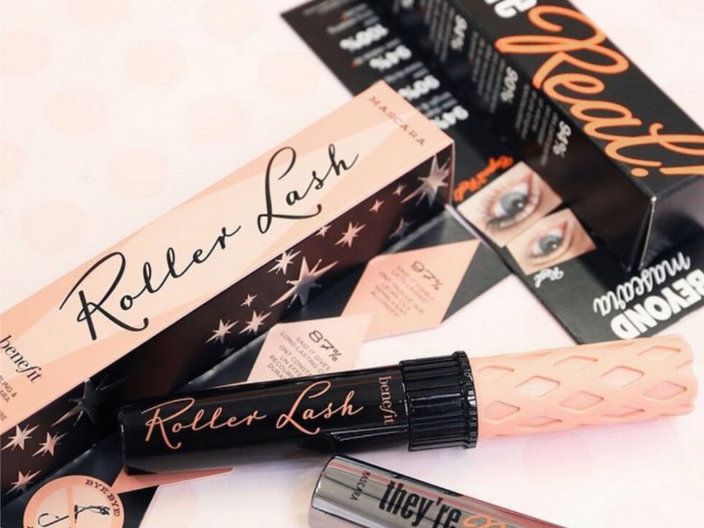 Two packages of mascara on pink surface