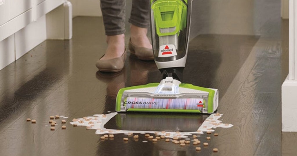 woman using Bissell Crosswave Wet Dry Vac to clean up milk and cereal