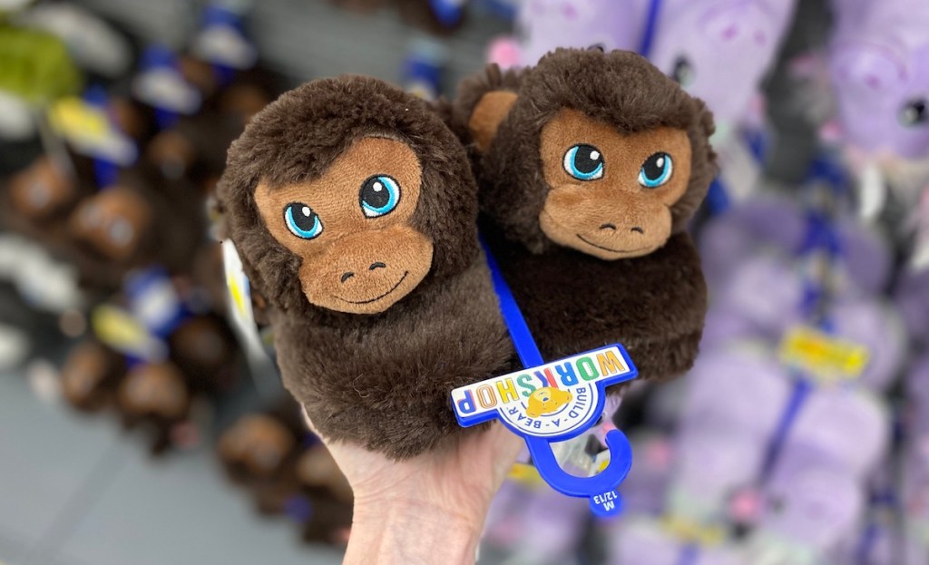 hand holding a pair of Build-A-Bear Monkey Slippers