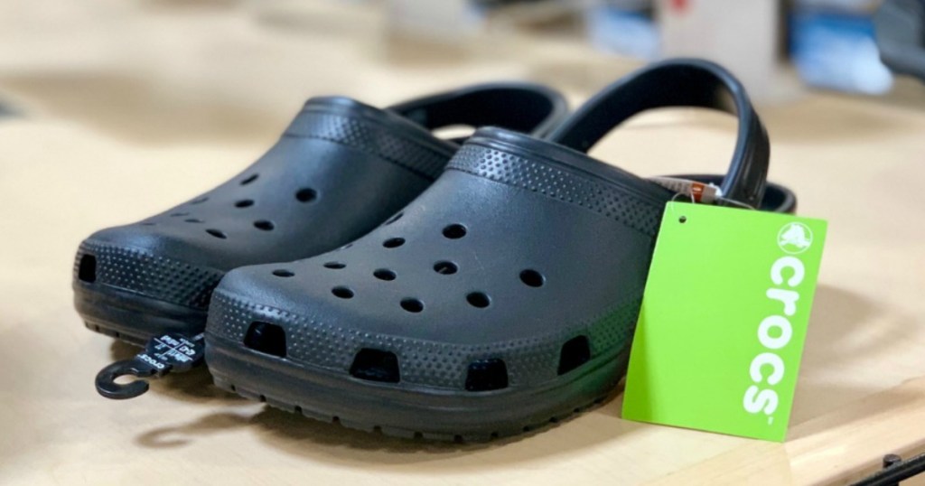 clogs with a green tag