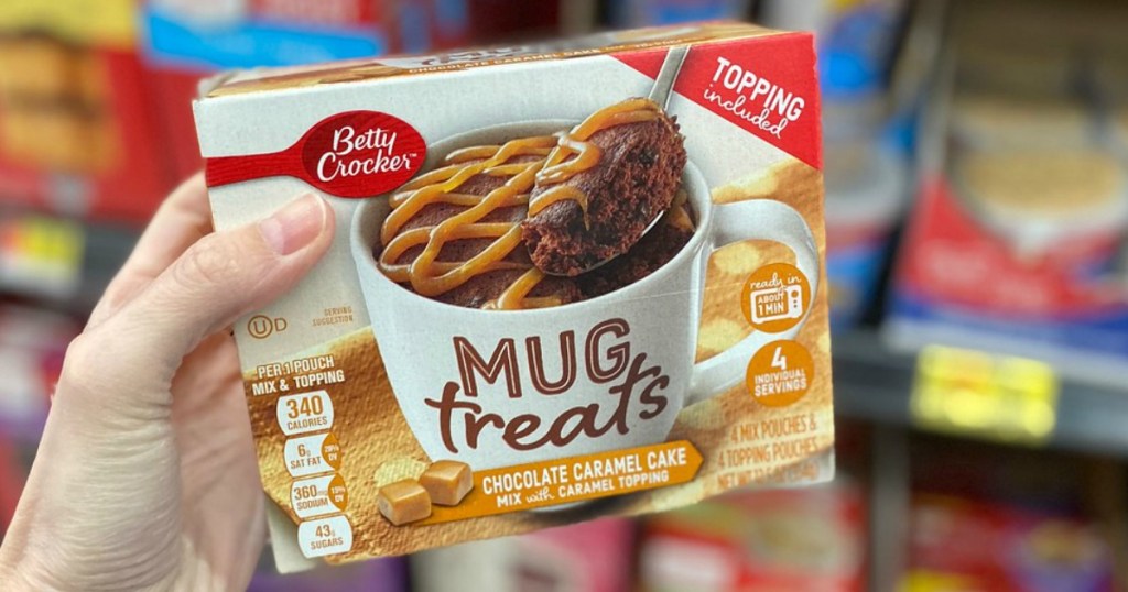 woman holding Duncan Hines Mug Cakes Chocolate Chip Cookie Cake Mix 4-Count Box