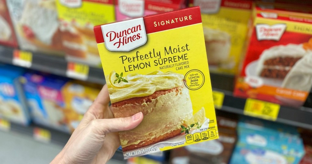 woman holding a box of lemon Duncan Hines cake mix