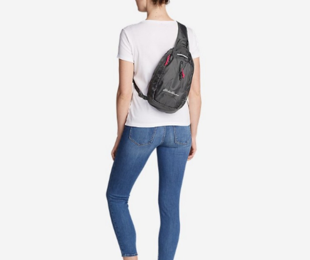 woman wearing Eddie Bauer Stowaway Packable Sling Bag